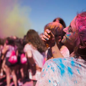 rear view young woman playing with holi powder